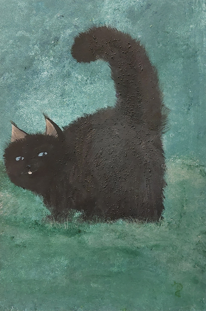 A mixed green background suggests a lawn with shrubs. A fluffy black cat holds his tail high in a greeting and looks back at you with it’s blue eyes. It’s pink tongue is sticking out ever so little.